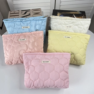 Quilted floral cosmetic bags in multiple colors with May Rabbit label and zipper closure