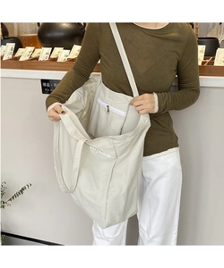 Detail view showing the spacious interior and inner zipper pocket of the canvas tote bag