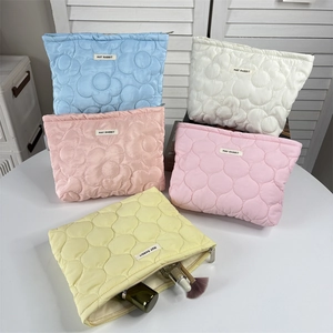 Quilted floral cosmetic bags in five pastel colors showing large storage space and neat texture