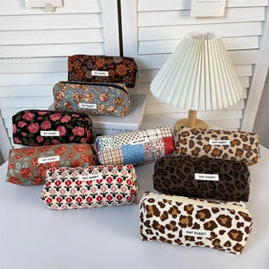 Detailed grid of vintage corduroy pouches in diverse floral, leopard, and plaid prints