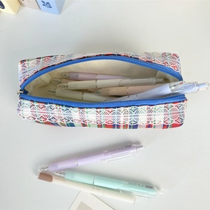 Close-up of checkered makeup bag with white lace trim showing large storage capacity