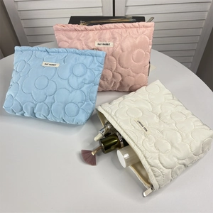 Quilted floral makeup bag in pink, blue, and white with large storage capacity