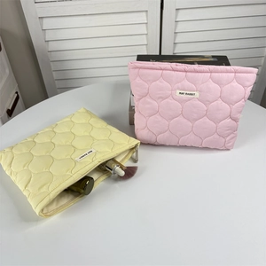 Detail of quilted floral makeup bag interior showing large capacity and soft fabric texture