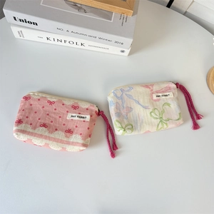 Portable canvas makeup bags with floral bow prints and May Rabbit woven labels