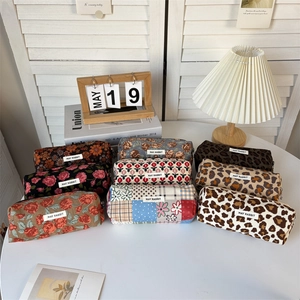 Various corduroy pouch designs with floral and leopard prints for makeup or stationery