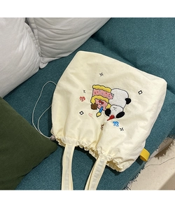 Detail of cute panda and cake embroidery on off-white canvas drawstring tote bag