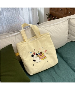 Detail of cute panda embroidery and towel stitching on a beige canvas tote bag