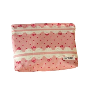 Pink canvas bow makeup bag with MAY RABBIT label and white lace patterns for travel