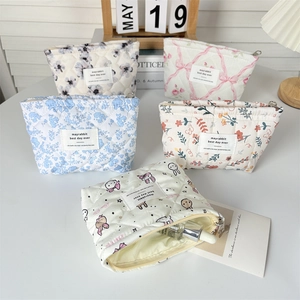 Quilted floral makeup bags in various patterns with metal zippers and fabric labels