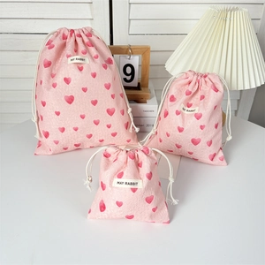 Detailed set of three pink heart drawstring bags in large, medium, and small sizes