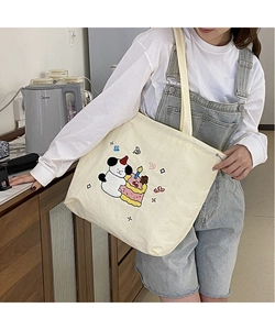 Close-up of cute cartoon dog embroidery and soft canvas fabric on this tote bag