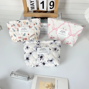 Flat lay of quilted floral cosmetic bags featuring vintage prints and cotton padding