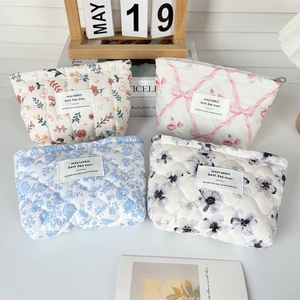 Quilted cotton floral makeup bags in four patterns with metal zippers and labels