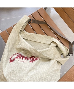 Close-up of light green checkered nylon tote bag with red Candy A GOOD DAY print