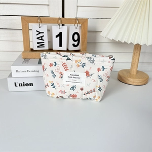 Close-up of a floral quilted cotton makeup bag with high-quality zipper detail