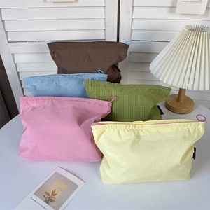 Detail of five colorful checkered nylon storage bags with large ring zipper pulls