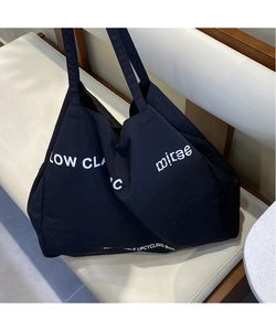 Macro view of the Low Classic canvas tote bag texture and eco-friendly printed lettering
