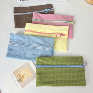 Close-up of five colorful mesh nylon pouches with contrast zippers and ring pullers