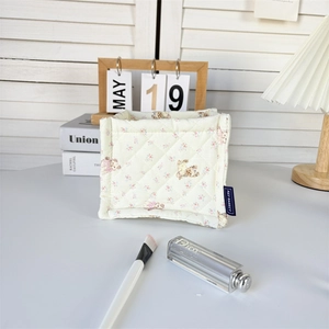 Detailed macro view of quilted desktop organizer featuring cute bear and floral patterns