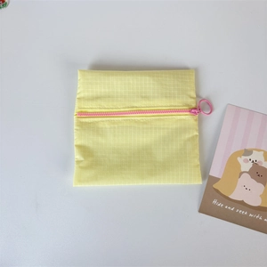Close-up of yellow waterproof nylon coin purse with pink zipper and large pull ring