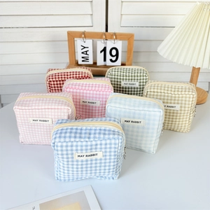 Detailed view of checkered mini storage bags in seven colors with May Rabbit brand label