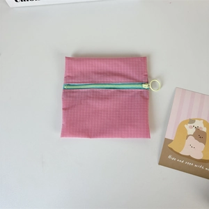 Pink checkered nylon coin purse detail with contrast mint green zipper and round ring puller