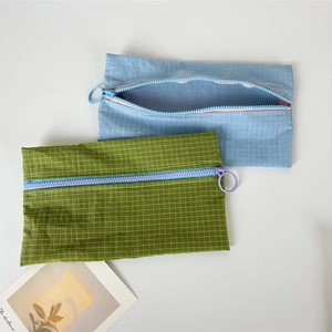 Close-up of waterproof nylon storage bags with grid texture and circular ring zippers