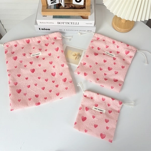 Detailed set of three pink heart drawstring bags in large, medium, and small sizes