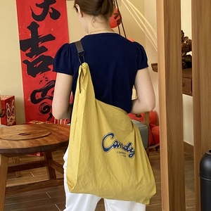 Casual yellow nylon crossbody bag with blue letter print and large capacity design