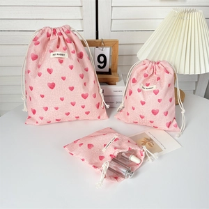 Set of three pink heart pattern drawstring storage bags in various sizes for organizers