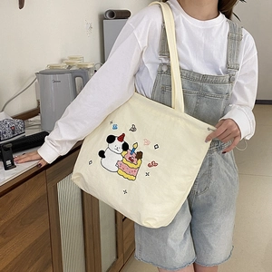 Cute off-white canvas tote bag with colorful puppy embroidery and drawstring closure