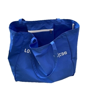 Navy blue canvas tote bag with white lettering and interior zipper pocket shown on white background