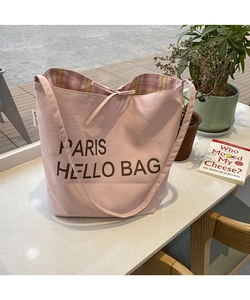 Pink canvas tote bag detail showing large capacity with colorful plaid lining