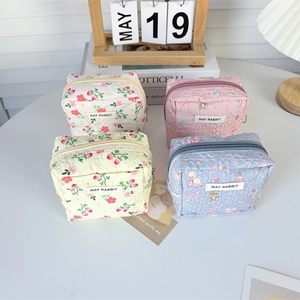 Detailed close-up of quilted cosmetic bags with cartoon prints and secure zippers