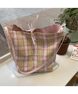 Detail of pink and yellow plaid canvas tote bag with drawstring closure and large interior