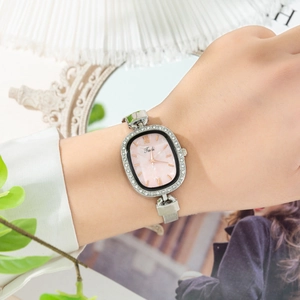 Close-up of elegant ladies' watch with rhinestone bezel and pink mother of pearl dial