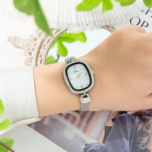 Women's quartz watch with mesh strap, oval pearl dial and crystal bezel on wrist