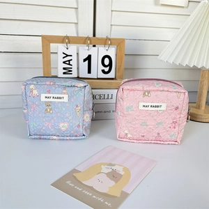 Detail of cute quilted cotton cosmetic bags with bear prints and zipper closure