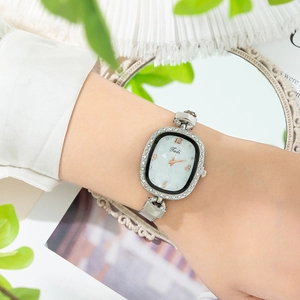 Elegant oval quartz watch for women with a rhinestone bezel and silver mesh strap
