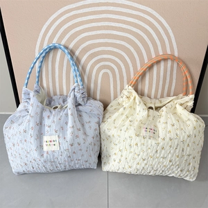 Floral chiffon shoulder bags in blue and cream with woven handles and button closure