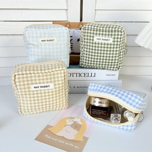 Set of four plaid canvas makeup bags in assorted colors with metal zippers for storage