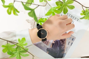 Detail of the starry black dial with rose gold case on a stylish silicone strap watch