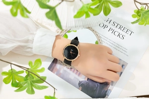 Close-up of starry sky watch with black silicone strap worn on a wrist in a lifestyle scene