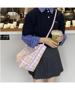 Close-up of pink and yellow plaid tote bag in a tea room setting for lifestyle use
