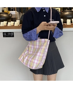 Detailed close-up of pink and yellow plaid canvas tote bag with a high-capacity design