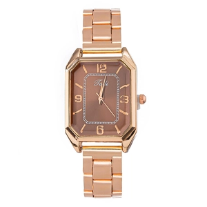 Macro detail of rose gold rectangular watch case with brown dial and metal link bracelet