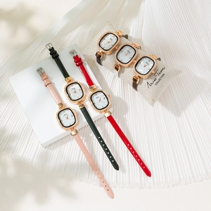 Elegant rose gold quartz watch set with diamond bezel and leather straps on display