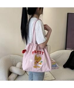 Close-up of pink canvas tote featuring cute nautical bear embroidery and PRTTY text