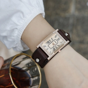 Elegant gold-tone rectangular quartz watch with Roman numerals and brown leather rivet strap