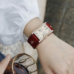 Elegant rectangular women's watch with rose gold diamond bezel and red-brown leather strap